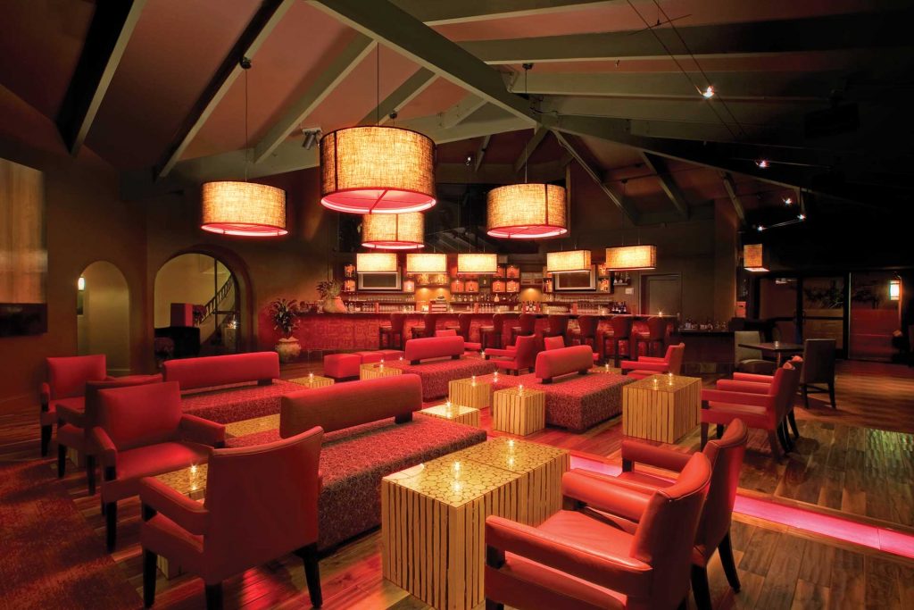 Photo of The Terrace Room lounge showcasing a full bar with modern seating and accent lighting